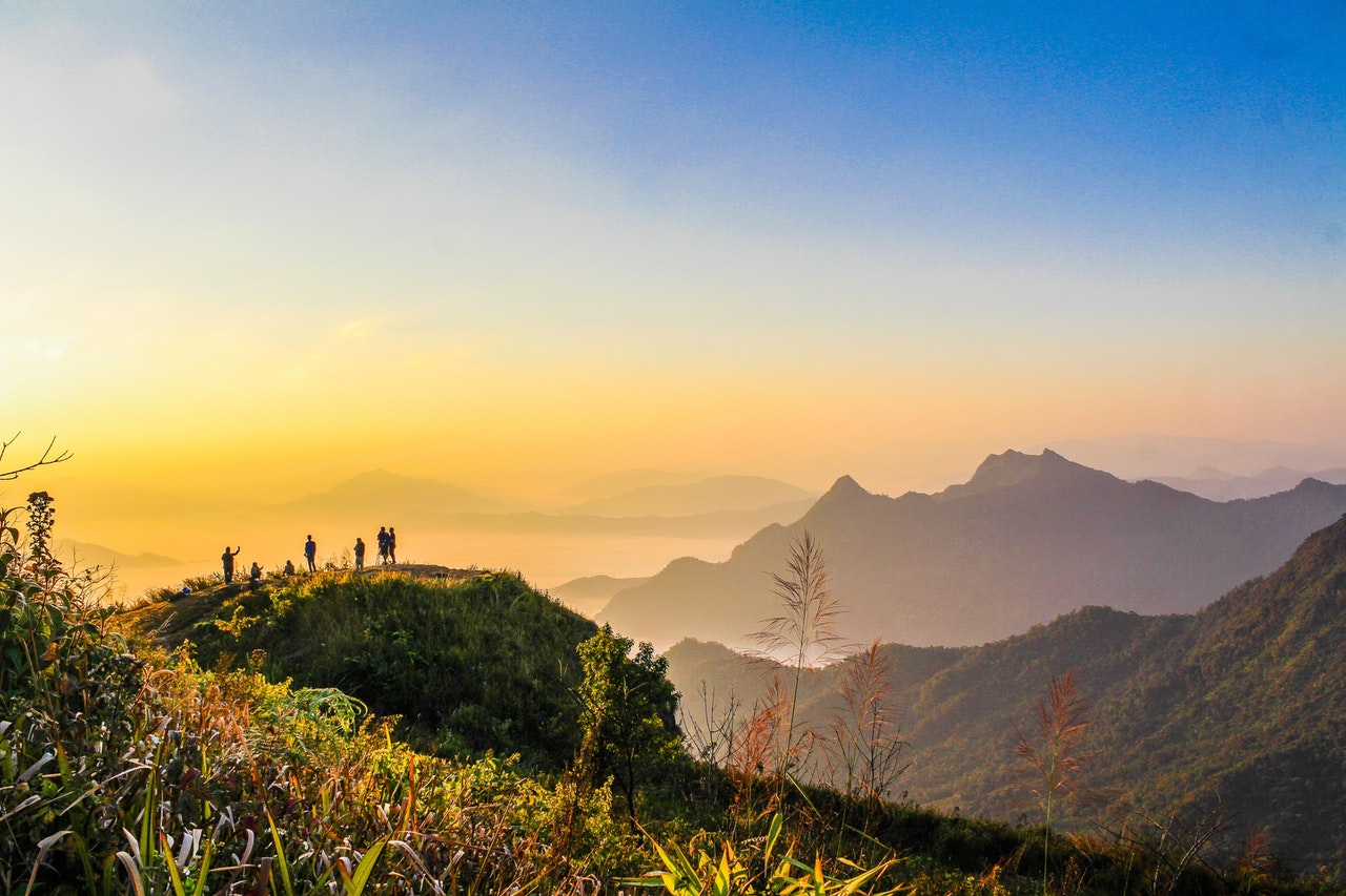 Home Photo Of People Standing On Top Of Mountain Near Grasses 733162 1